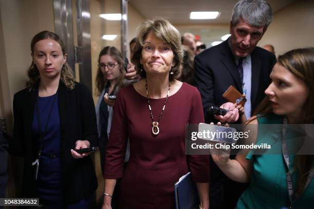 Sen. Lisa Murkowski talks with reporters as she heads for the weekly Senate Republican policy luncheon at the U.S. Capitol October 02, 2018 in...