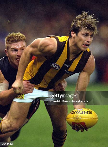 Gary Moorcroft for Essendon tackles Shane Crawford for Hawthorn, in the match between the Essendon Bombers and the Hawthorn Hawks, during round 19 of...