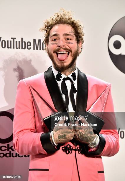 Post Malone, winner of the Favorite Male Artist - Pop/Rock award, poses in the press room during the 2018 American Music Awards at Microsoft Theater...