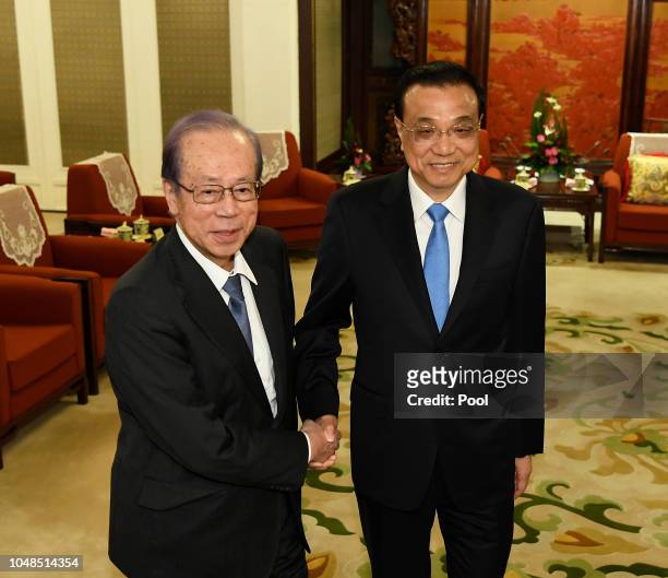 Chinese Premier Li Keqiang, right, shakes hands with Former Japanese Prime Minister Yasuo Fukuda ,left, before a meeting at the Zhongnanhai...