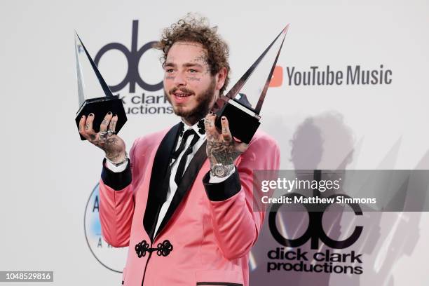 Post Malone, winner of the Favorite Male Artist - Pop/Rock award poses in the press room during the 2018 American Music Awards at Microsoft Theater...