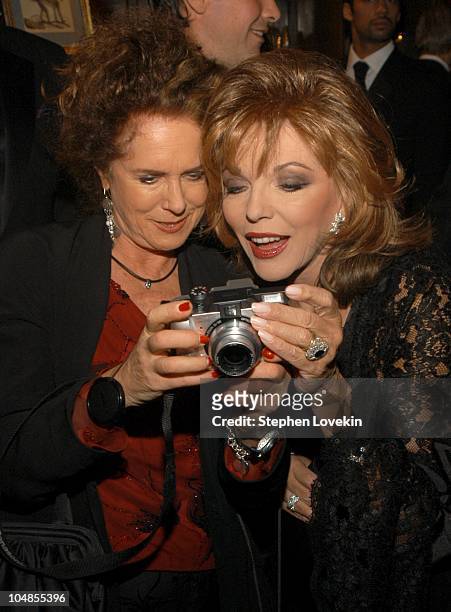 Joan Jeddell shows Joan Collins her picture during Official 2003 Academy of Motion Picture Arts and Sciences Oscar Night Party at Le Cirque 2000 at...