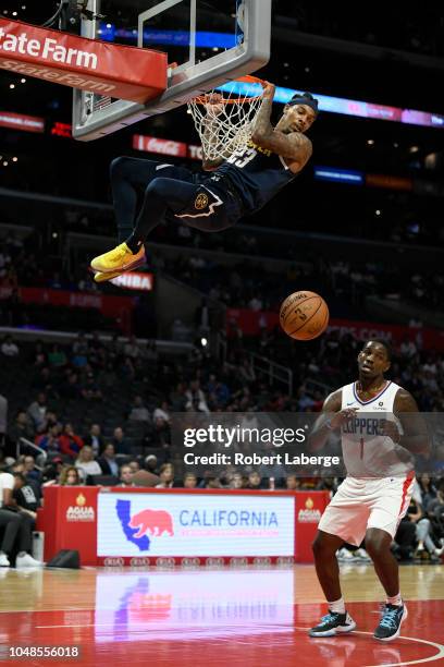 DeVaughn Akoon-Purcell of the Denver Nuggets makes a dunk against Jawun Evans of the Los Angeles Clippers on October 9, 2018 at STAPLES Center in Los...