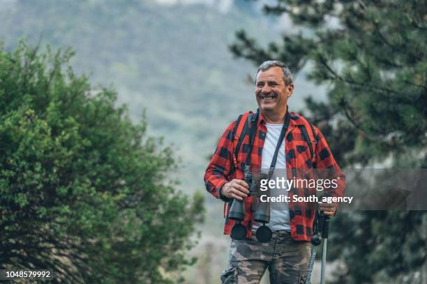 hiker conquering nature - hiking mature man stock pictures, royalty-free photos & images
