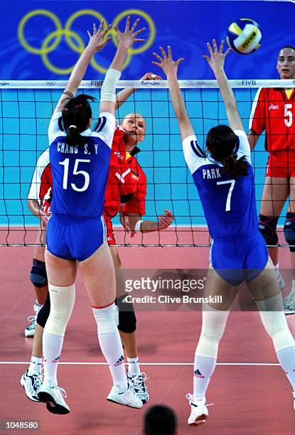 So Yun Chang and Mee-Kyung Park of Korea combine to defend an attack from Susanne Lahme of Germany during the womens Volleyball preliminaries at the...