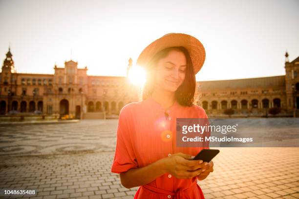 using mobile phone. - seville stock pictures, royalty-free photos & images