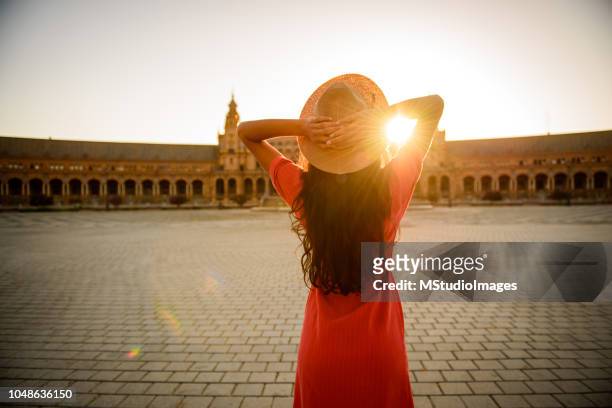 woman enjoying sunrise. - seville stock pictures, royalty-free photos & images