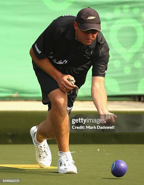 Richard Girvan skipper of New Zealand sends down a bowl in the Lawn Bowls Mens Triples match between New Zealand and Brunei Darussalam at JN Sports...