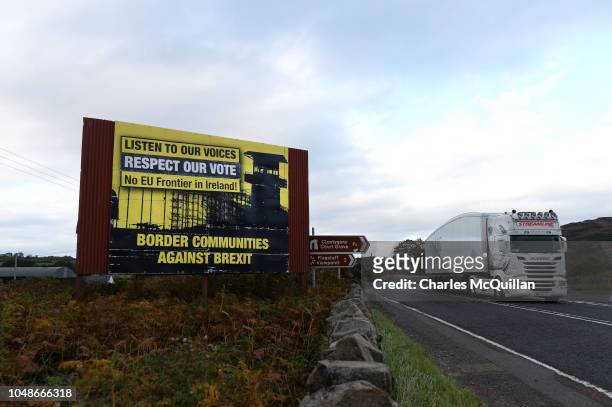 Lorry crosses the border past a Border Communities Against Brexit billboard on October 9, 2018 in Newry, Northern Ireland. Talks on the Irish border...