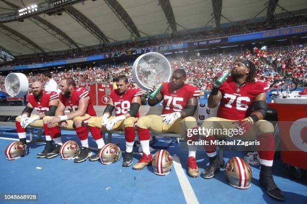 Erik Magnuson, Mike Person, Weston Richburg, Laken Tomlinson and Garry Gilliam of the San Francisco 49ers sit on the bench during the game against...