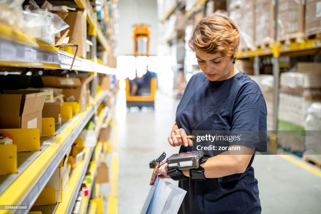 Woman pushing buttons on wearable barcode reader