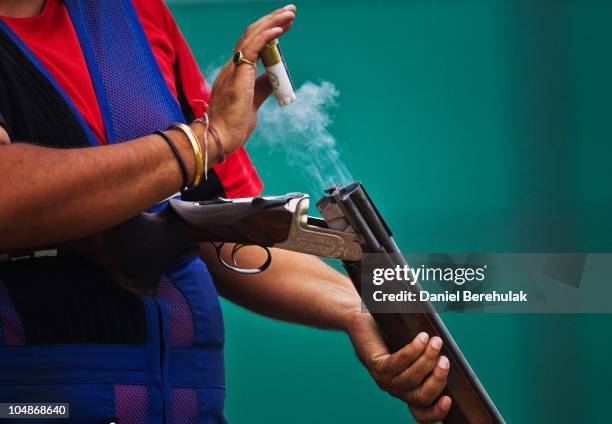 Silver Medal winner Ronjan Sodhi of India unloads his shells during the Pairs Double Trap Mens Event at Dr Karni Singh Shooting Range during day two...