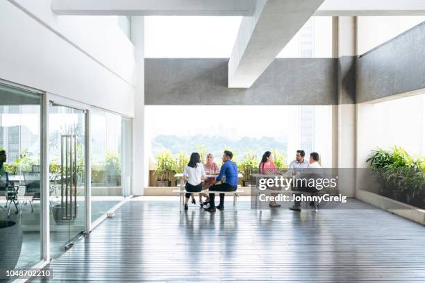 modern open plan office space with business people - johnny stark stock pictures, royalty-free photos & images