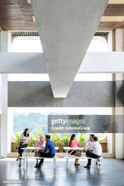 modern office interior with large window and people on coffee break - johnny stark stock pictures, royalty-free photos & images