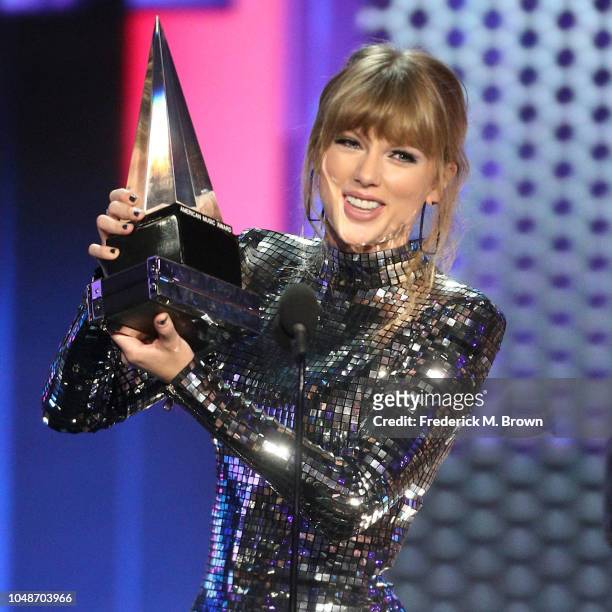 Taylor Swift accepts the Artist of the Year award onstage during the 2018 American Music Awards at Microsoft Theater on October 9, 2018 in Los...