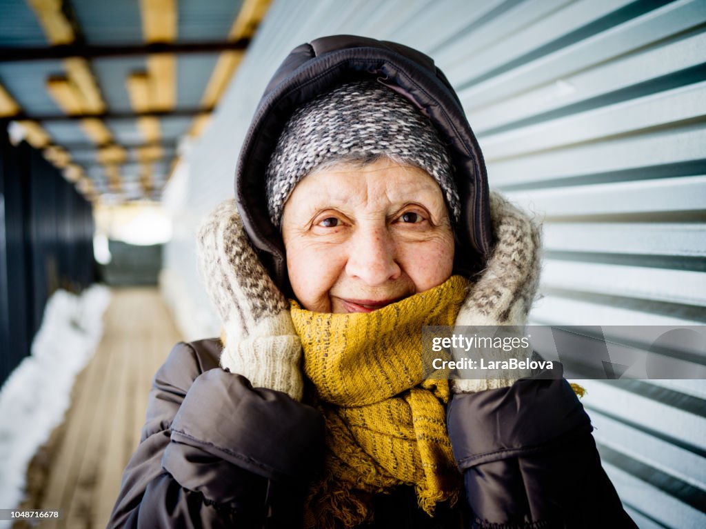 Portrait of women 74 old outdoors in winter