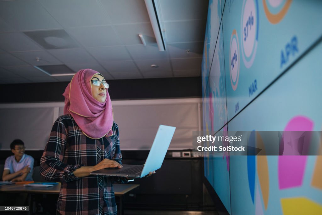 Young Woman Programming a Data Presentation