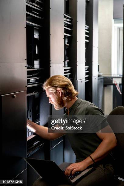 computer server technician working in a university - man server room stock pictures, royalty-free photos & images