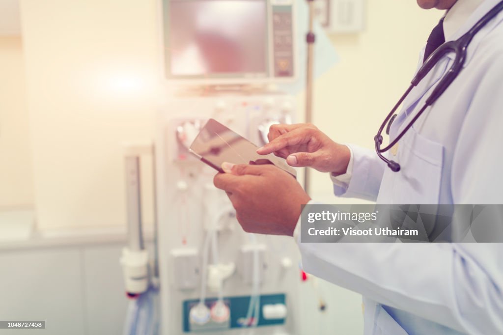 Doctor is working with tablet computer at the hospital emergency room