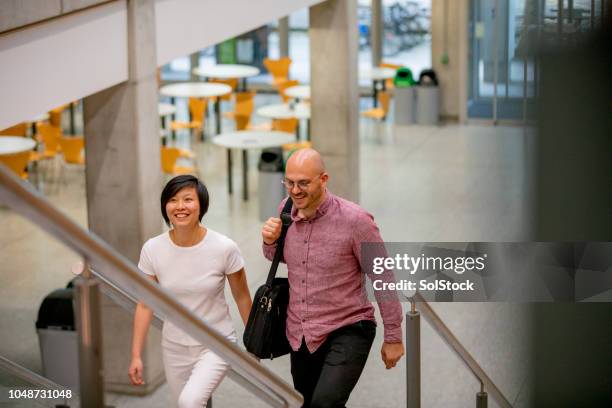 adult students walking to their university lecture - university professor stock pictures, royalty-free photos & images