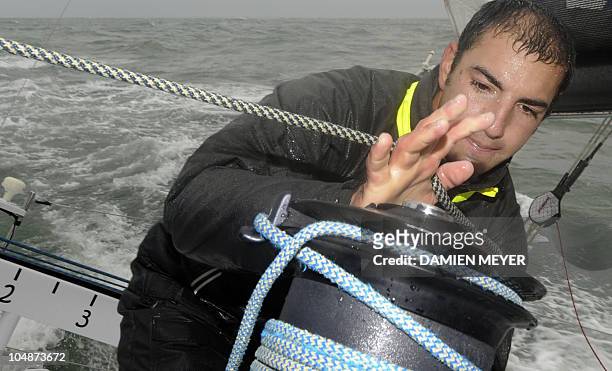 French skipper Damien Seguin sails on his "Des pieds et des mains" monohull on October 4, 2010 off the coast of Saint Nazaire western France during a...
