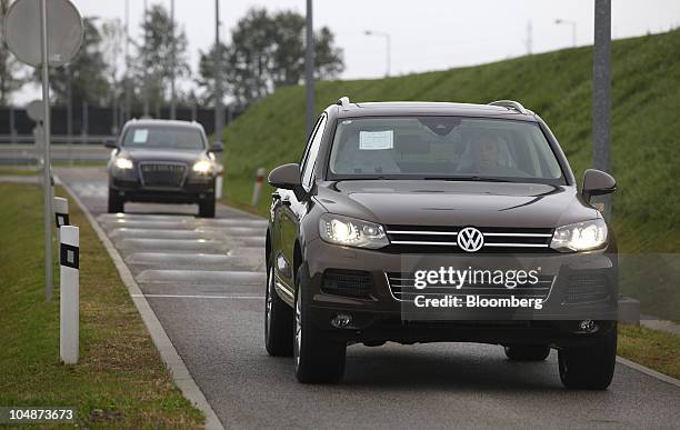Touareg, right, and Audi Q7 sport-utility vehicles are taken for a test drive at the Volkswagen AG factory in Bratislava, Slovakia, on Tuesday, Oct....