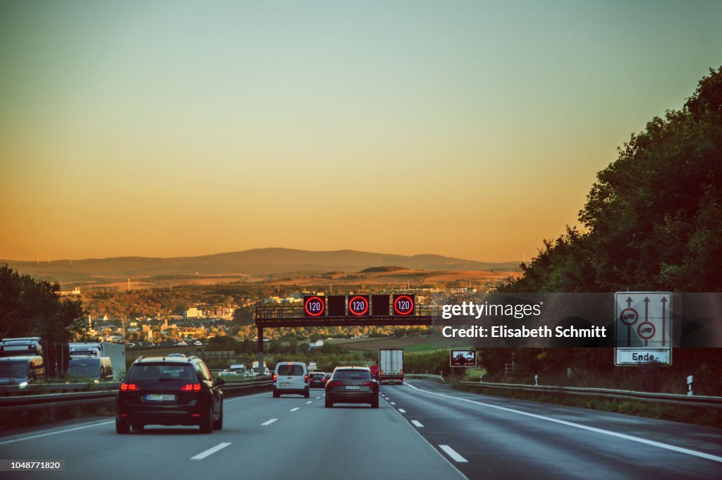 Driving on a freeway / motorway / "Autobahn" at sunset