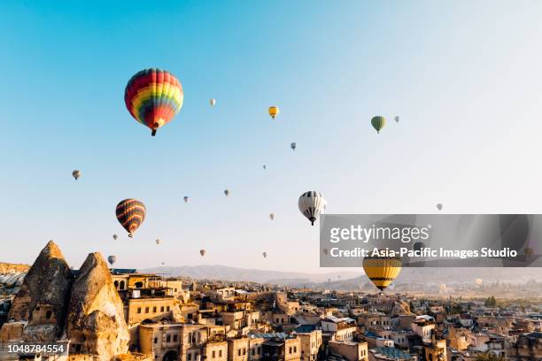hot air balloons over cappadocia at sunrise，turkey - turkey middle east stock pictures, royalty-free photos & images