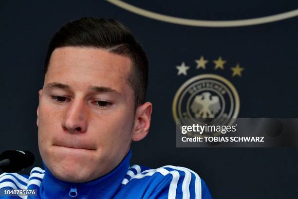 Germany's midfielder Julian Draxler attends a press conference on October 10, 2018 in Berlin ahead of a Nations League match against the Netherlands...