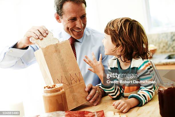 father and son making lunch - bread packet stock pictures, royalty-free photos & images