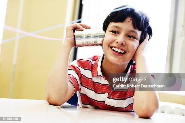 boy listening to can phone - listening tin can stock pictures, royalty-free photos & images