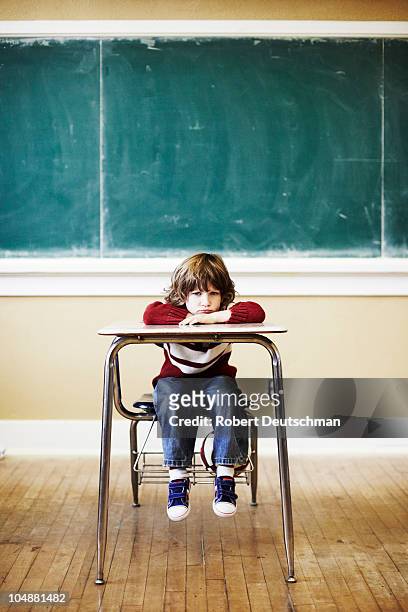 boy at desk - boy sitting stock pictures, royalty-free photos & images