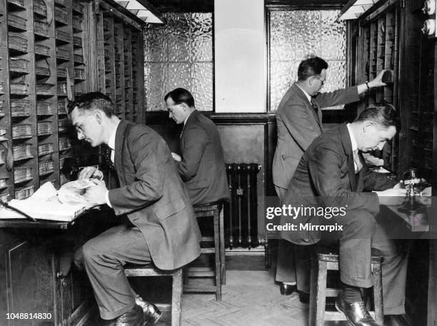 Finger Print Department. Section of search room, officers searching records. Scotland Yard. London. May 1929.