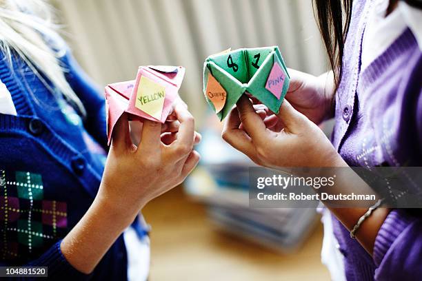 two girls playing origami fortune game - origami spiel stock-fotos und bilder