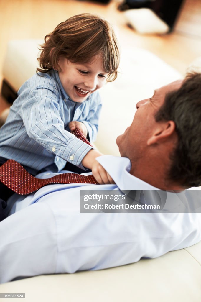 Son adjusting father's tie