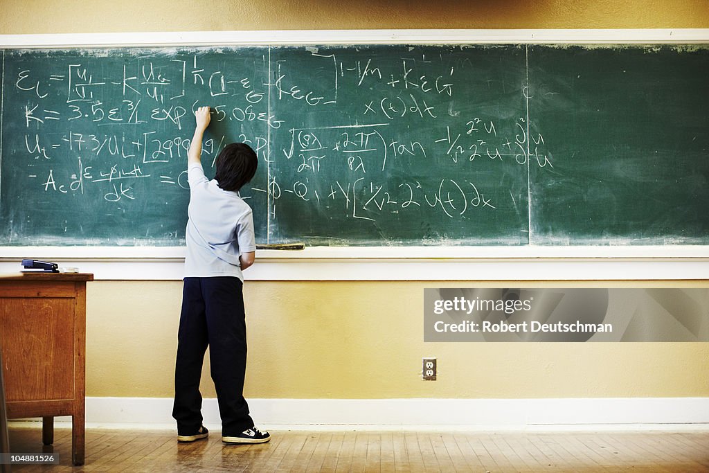 Boy Doing Math At Chalkboard High-Res Stock Photo - Getty Images