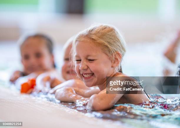 laughing girl in pool - swimming stock pictures, royalty-free photos & images