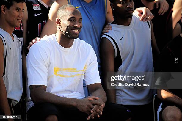 Kobe Bryant of the Los Angeles Lakers poses with the 'House of Hoops' contest by Foot Locker players after the contest on October 6, 2010 in...