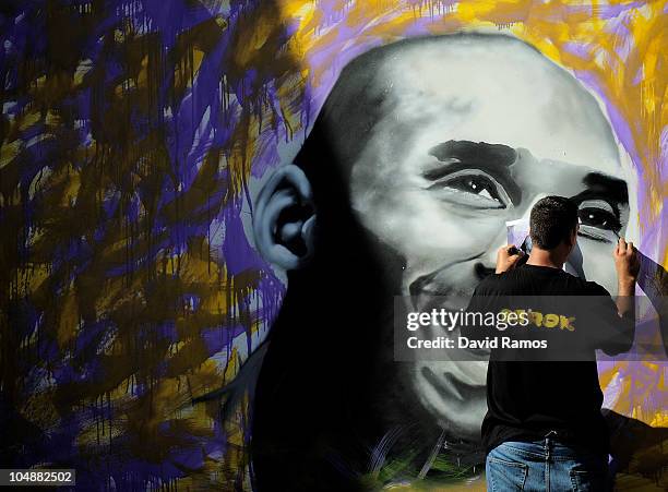 Graffiti artist finishes a portrait of Kobe Bryant of the Los Angeles Lakers during the 'House of Hoops' contest by Foot Locker on October 6, 2010 in...