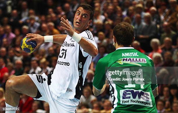 Momir Ilic of Kiel is challenged by of Goeppingen during the Toyota HBL match between THW Kiel and Goeppingen at the Sparkassen Arena on October 6,...