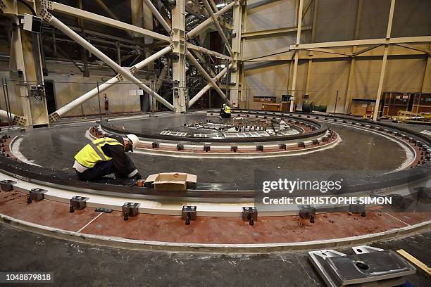 Employees work inside the ITER construction site where will be installed the Tokamak, a confinement device being developed to produce controlled...