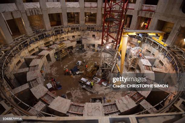 Employees work inside the ITER construction site where will be installed the Tokamak, a confinement device being developed to produce controlled...