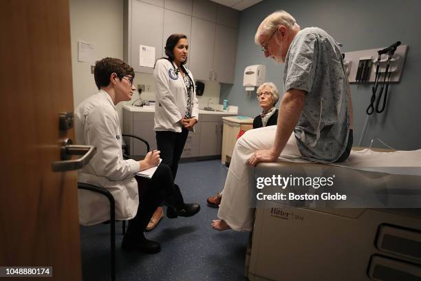 From left, students Stephanie Bond and Neiha Kidwai take part in role-play simulation training for end-of-life care with actors Lisa Piehler and...