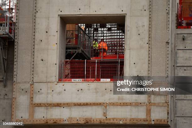 Employees work outside the ITER construction site where will be installed the Tokamak, a confinement device being developed to produce controlled...