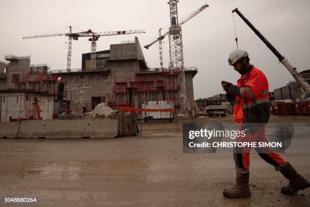 An employee walks at the ITER construction site where will be installed the Tokamak, a confinement device being developed to produce controlled...