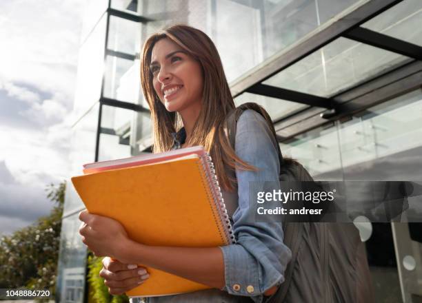 happy female college student smiling - education building stock pictures, royalty-free photos & images