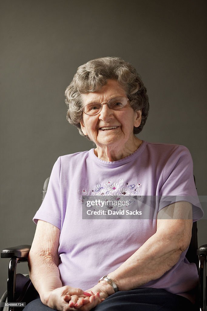 Senior woman in wheelchair, smiling