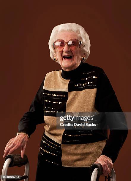 senior woman with walker laughing - centenaire et plus photos et images de collection