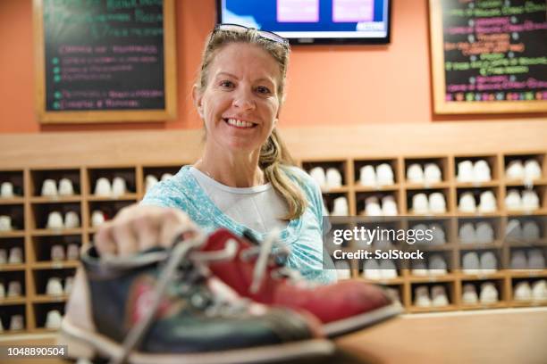 handing out the bowling shoes - bowling shoe stock pictures, royalty-free photos & images