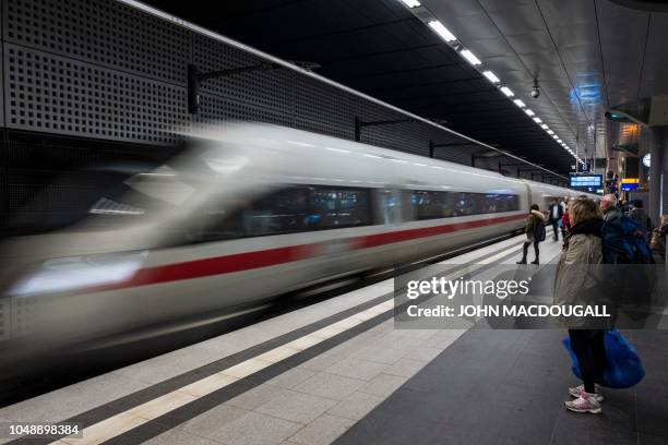 An Inter City Express train of Germany's Deutsche Bahn arrives at Berlin's Hauptbahnhof main railway station on October 10, 2018. - Deutsche Bahn...